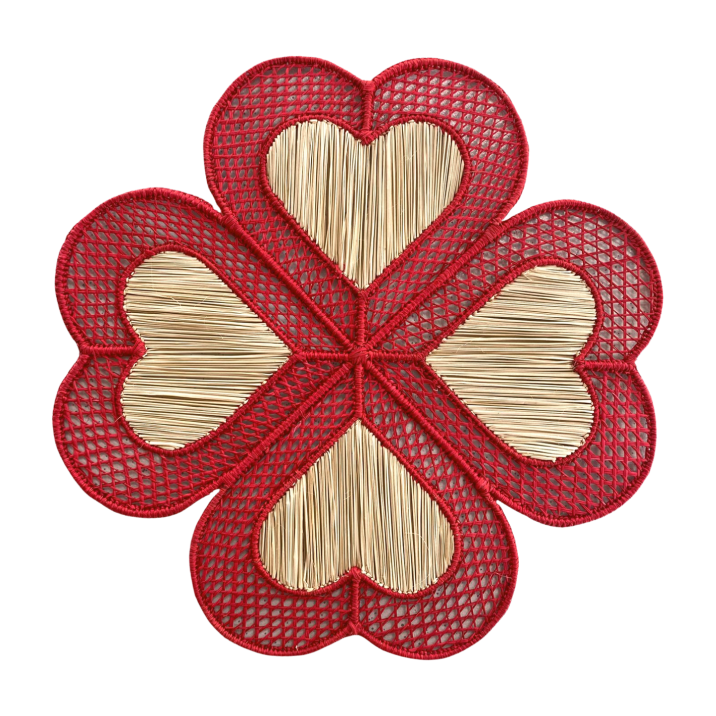 A woven placemat with a red heart and clover design, made from palm fibers.